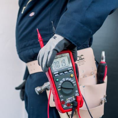 Homewize Electric technician testing a circuit with a meter